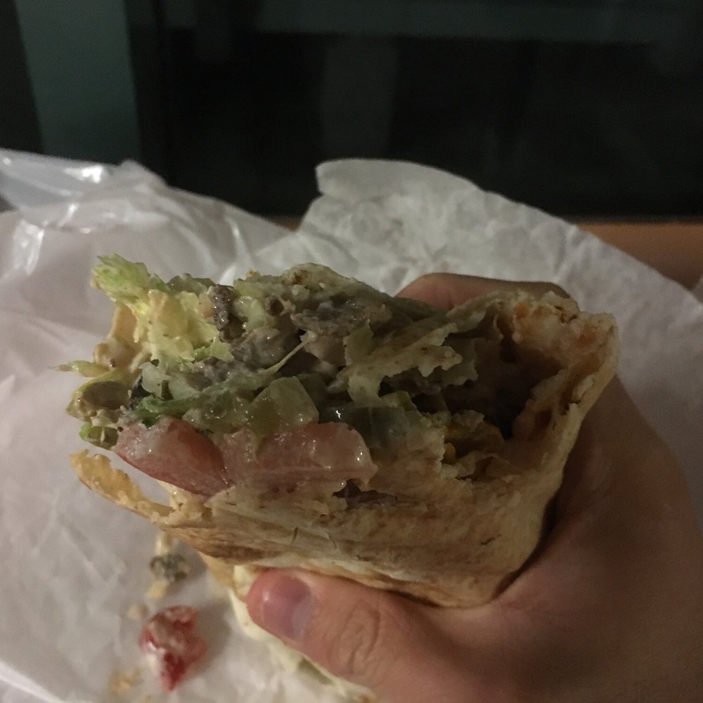 Lazeez Shawarma - a hand holding a sandwich - Mediterranean Near Me - Waterloo, Ontario