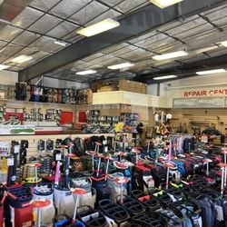 Roger Dunn Golf Hawaii - Large Selection of golf bags, repair center, putting green to the left