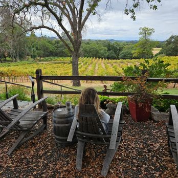 PaZa Estate Winery - a woman sitting in a chair on a patio - Wine Tasting Room Near Me - Auburn, California PaZa Estate Winery - a woman sitting in a chair on a patio - Wine Tasting Room Near Me - Auburn, California