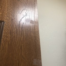 Fake wood on door held on with scotch tape