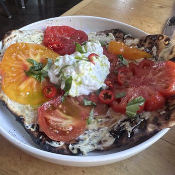 Attraversiamo - Stracciatella cheese over Brentwood heirloom tomatoes over a naan! - Cocktail Bars Near Me - Brentwood, California