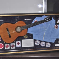 Frame It - A shadow box tribute featuring an acoustic guitar and various awards.