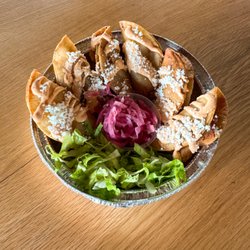Crispy potato tacos topped with chipotle oaxacan style crema, side of shredded lettuce and citrus pickled onions.