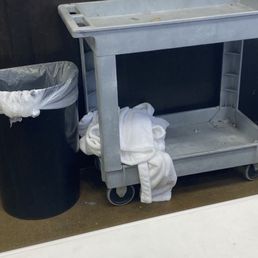 White robe tossed on dirty cart next to the trash by the manager.  Couldn't she hung it up?   No one else was in line.