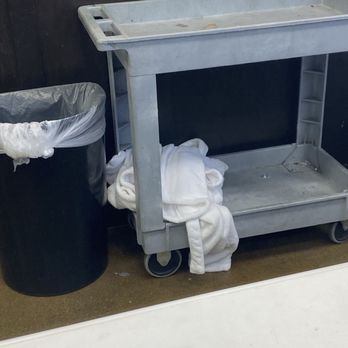 OC Goodwill Boutique - White robe tossed on dirty cart next to the trash by the manager.  Couldn't she hung it up?   No one else was in line. - Thrift Stores Near Me - Huntington Beach, California