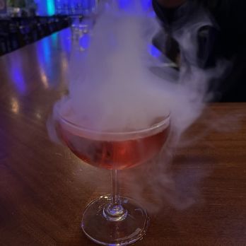 The Post Bar - a cocktail with smoke coming out of it - Sports Bars Near Me - Fairview, New Jersey
