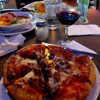 Uccello's - Downtown - 9' Uccelos specialty pizza with a delicious glass of Joel Gott Pinot Noir. - Sports Bars Near Me - Grand Rapids, Michigan