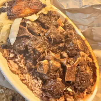 Nolan’s Cuisine - Sorry my phone settings has it looking a bit orange.  Oxtails with rice & peas. - Caribbean Near Me - Elmont, New York