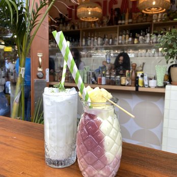 Tropicale - Tropi Tropi (left, white colored drink) and Medium Piña Colada (right) - Latin American Near Me - Portland, Oregon Tropicale - Tropi Tropi (left, white colored drink) and Medium Piña Colada (right) - Latin American Near Me - Portland, Oregon