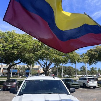 Cali Aji - a car with a flag on the hood - Latin American Near Me - Boca Raton, Florida Cali Aji - a car with a flag on the hood - Latin American Near Me - Boca Raton, Florida