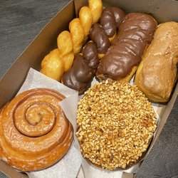 Chuck's Donut Shop - Glazed twist, chocolate twist, chocolate bar, maple bar, Persian, maple/nut Persian, Apple fritters (under the Persian)