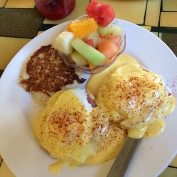Wild Mountain Cafe - Classic Eggs Benedict with a potato cake and a cup of fruit - American Near Me - Seattle, Washington Wild Mountain Cafe - Classic Eggs Benedict with a potato cake and a cup of fruit - American Near Me - Seattle, Washington