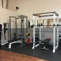 Intrinsic Chiropractic & Sports Rehab - Squat/multi use racks and barbells, along with bumper plates and small kettlebells