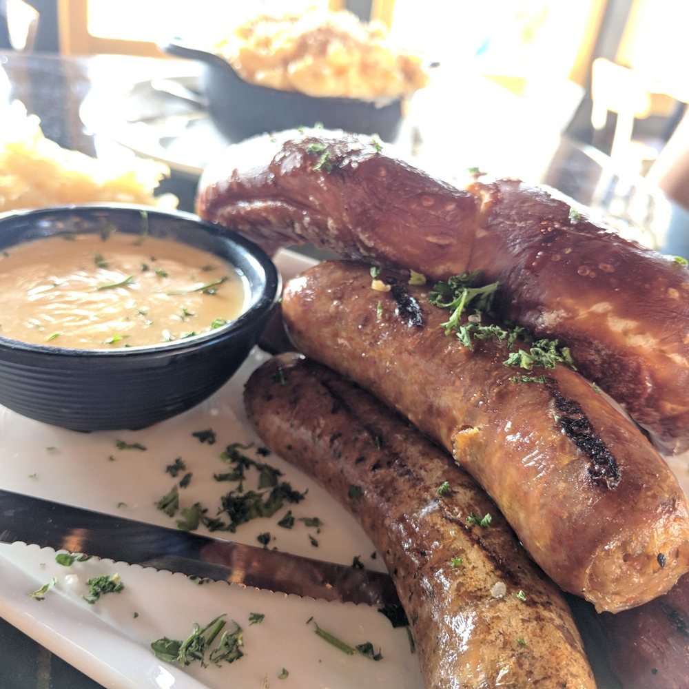 Basin 141 - Sausage platter, with a big pretzel, cheese dip, saurkraut, and mustard. - Gastropubs Near Me - Monrovia, California Basin 141 - Sausage platter, with a big pretzel, cheese dip, saurkraut, and mustard. - Gastropubs Near Me - Monrovia, California