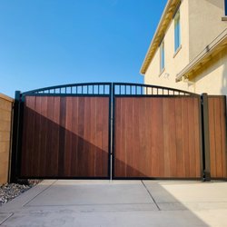 Del Rey Fabrication - Custom gate and panel. Arched frame with Stained redwood pickets.
