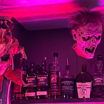 Herb's Hideout - Masks behind the bar - Lounges Near Me - Denver, Colorado