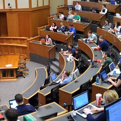University of Notre Dame Law School - Eck Hall McCartan Courtroom in classroom setup - screen behind lecturer is covering judges bench...photo from NDLS website.