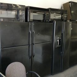 PG Used Appliances - Black refrigerators with microwaves on top