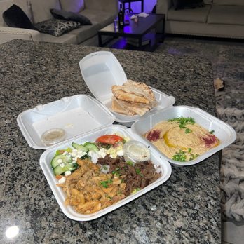Truly Greek - Beef and chicken platter topped yellow rice, potato salad, Greek salad and a side of hummus served with a side of pita. - Mediterranean Near Me - Brandon, Florida