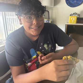 MK's International Kitchen - Child eating Samosa - Mexican Near Me - Fresno, California MK's International Kitchen - Child eating Samosa - Mexican Near Me - Fresno, California