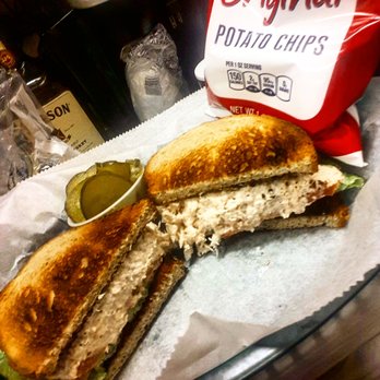 Grumpy's Tavern - a chicken sandwich with pickles - Dive Bars Near Me - Philadelphia, Pennsylvania