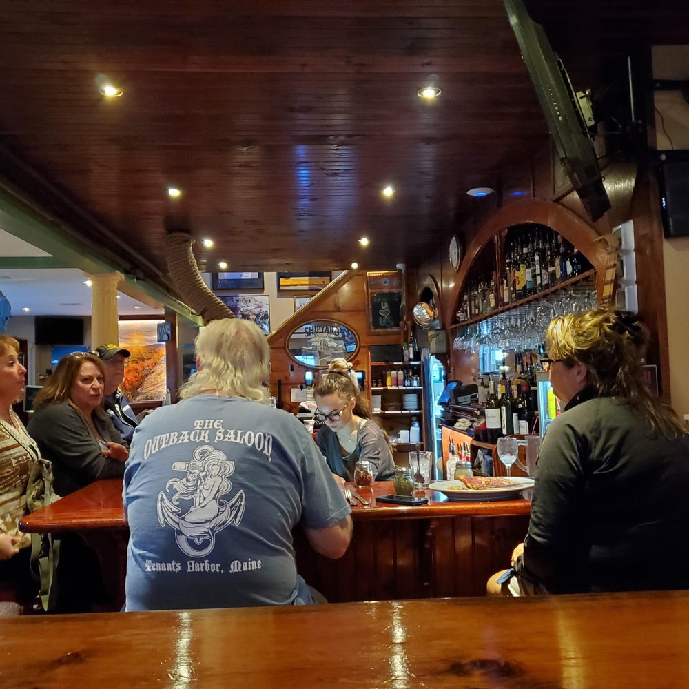 a group of people sitting at a bar