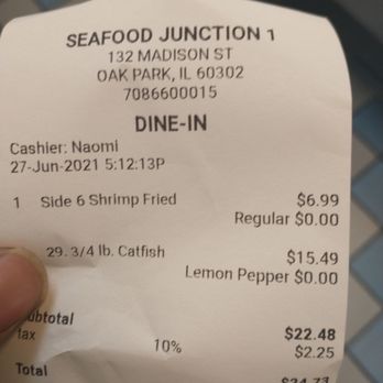 Seafood Junction - a person holding a receipt - Seafood Near Me - Oak Park, Illinois