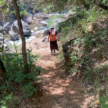 Old Bear River Bridge - Hiker on main dirt trail that leads you westwards next to Bear River. - Landmarks & Historical Buildings Near Me - Colfax, California