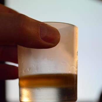 Johnnie Walker - a hand holding a shot of alcohol - Beer, Wine & Spirits Near Me - Los Angeles, California