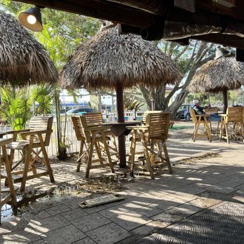 Tiki Bar - tables and chairs under thatched umbrellas - Tiki Bars Near Me - Fort Myers, Florida Tiki Bar - tables and chairs under thatched umbrellas - Tiki Bars Near Me - Fort Myers, Florida