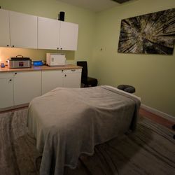 Healthy Body Massage - Private Orlando massage treatment room with a massage table, hot towel cabinet, and warming equipment.