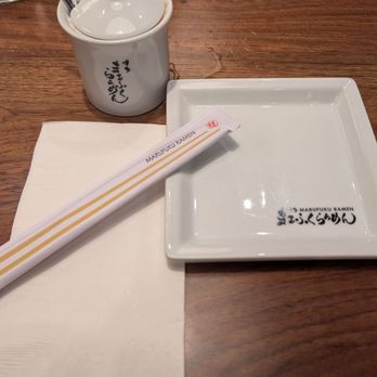 Marufuku Ramen - Marufuku branded plate, chopsticks and cayenne pepper powder pot artfully arranged. - Ramen Near Me - Dublin, California