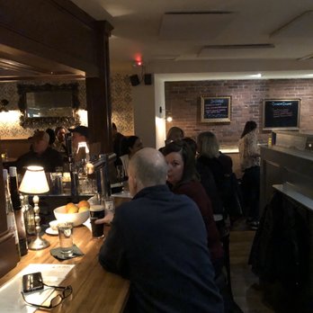 The James - The cozy bar from my perch as a two-top next to some lovely stonework - Irish Pub Near Me - Needham, Massachusetts