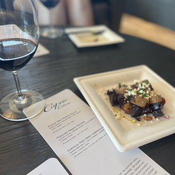 Caprio Cellars - a plate of food and a glass of wine - Wineries Near Me - Walla Walla, Washington