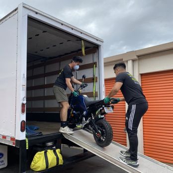 Virtuous Moving Services - Unloading a carefully packed motorcycle - Movers Near Me Virtuous Moving Services - Unloading a carefully packed motorcycle - Movers Near Me