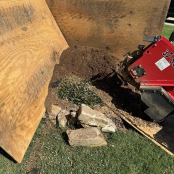 Brent's Stump Grinding - Protected house while grinding stump. - Tree Services Near Me