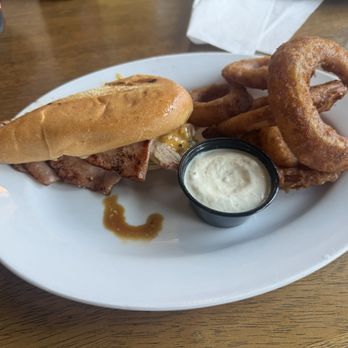 Kelly's Bar & Grill - Cubano sandwich (cut in half), with onion rings - American Near Me - Newport, Washington Kelly's Bar & Grill - Cubano sandwich (cut in half), with onion rings - American Near Me - Newport, Washington