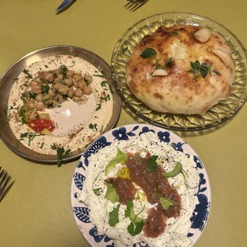 Shukette - (From top right) Frena bread, Labneh dip, and hummus - Middle Eastern Near Me - New York, New York