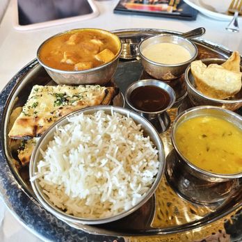 Bombay Darbar - Thali with butter chicken. Regular Naan is included, but I opted for garlic Naan for an additional $1 - Indian Near Me - Doral, Florida Bombay Darbar - Thali with butter chicken. Regular Naan is included, but I opted for garlic Naan for an additional $1 - Indian Near Me - Doral, Florida