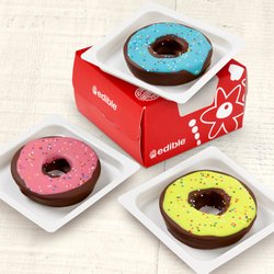 Edible Arrangements - Each donut-shaped slice of fresh, crisp Granny Smith apple is carefully hand-dipped in real, semisweet chocolate, then artfully decorated.