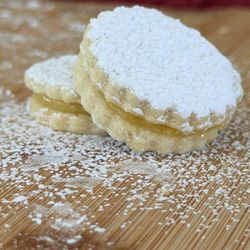 Lemon Curd Butter Cookie Minis - These tender, buttery mini cookies are scalloped, dusted in powdered sugar
