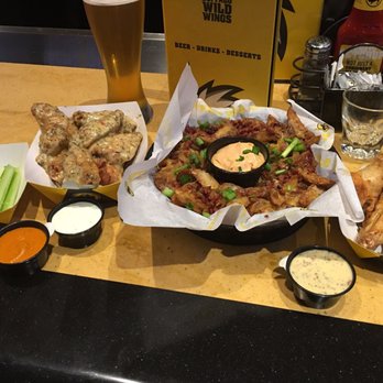 Buffalo Wild Wings - Lunch at Buffalo Wild Wings. Garlic parmesan / spicy garlic mix. Wings, loaded potato wedges and al'rye ipa from sunking. - American Near Me - Indianapolis, Indiana