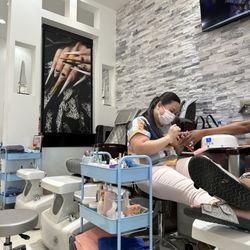 INail & Beyond - Our best nail tech with her client
