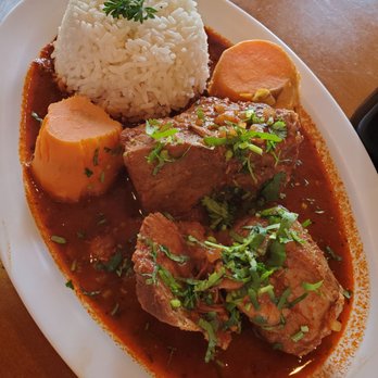 Brasas Peruanas - Adobo Limeno. Slow cooked pork in a rich red sauce with sweet potato and rice. - Peruvian Near Me - Round Rock, Texas