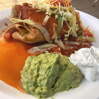 El Faro - El Faro. Red smothered beef chimichanga with sour cream and guacamole. - Mexican Near Me - Truth or Consequences, New Mexico