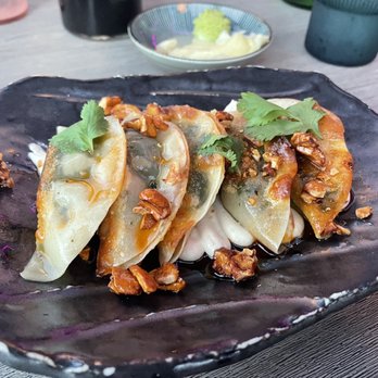 Lucky Robot Restaurant - spinach & tofu dumplings cashew cheese, red curry oil, cilantro - Sushi Bars Near Me - Austin, Texas Lucky Robot Restaurant - spinach & tofu dumplings cashew cheese, red curry oil, cilantro - Sushi Bars Near Me - Austin, Texas