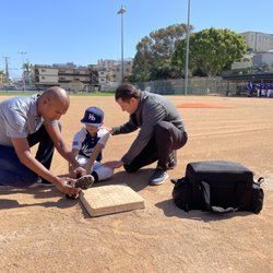 Moin Salah, MD, MBA - Working with local little league players during their games.