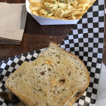 Rustic On the Green - This is the patty melt, took a bite first and the Italian fries. - New American Near Me - Albuquerque, New Mexico