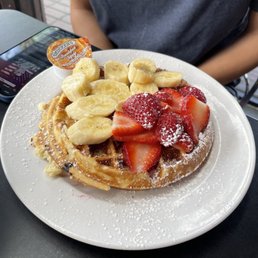 a waffle topped with strawberries and bananas a waffle topped with strawberries and bananas