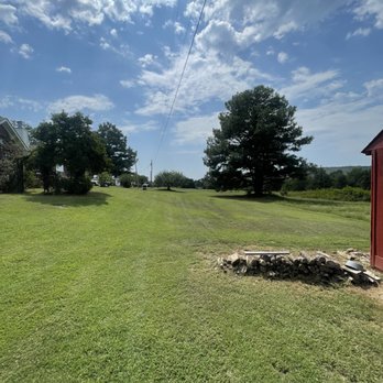 High Grass - a field with a red shed and trees - Lawn Services Near Me